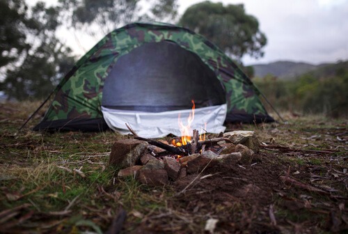 Green Camouflage Tent fire rocks front