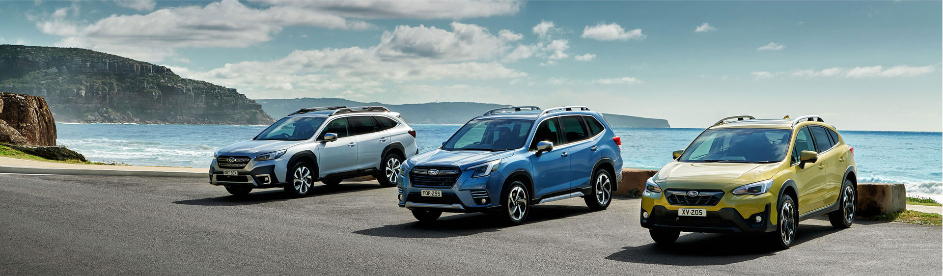 Subaru cars on display by the coastline