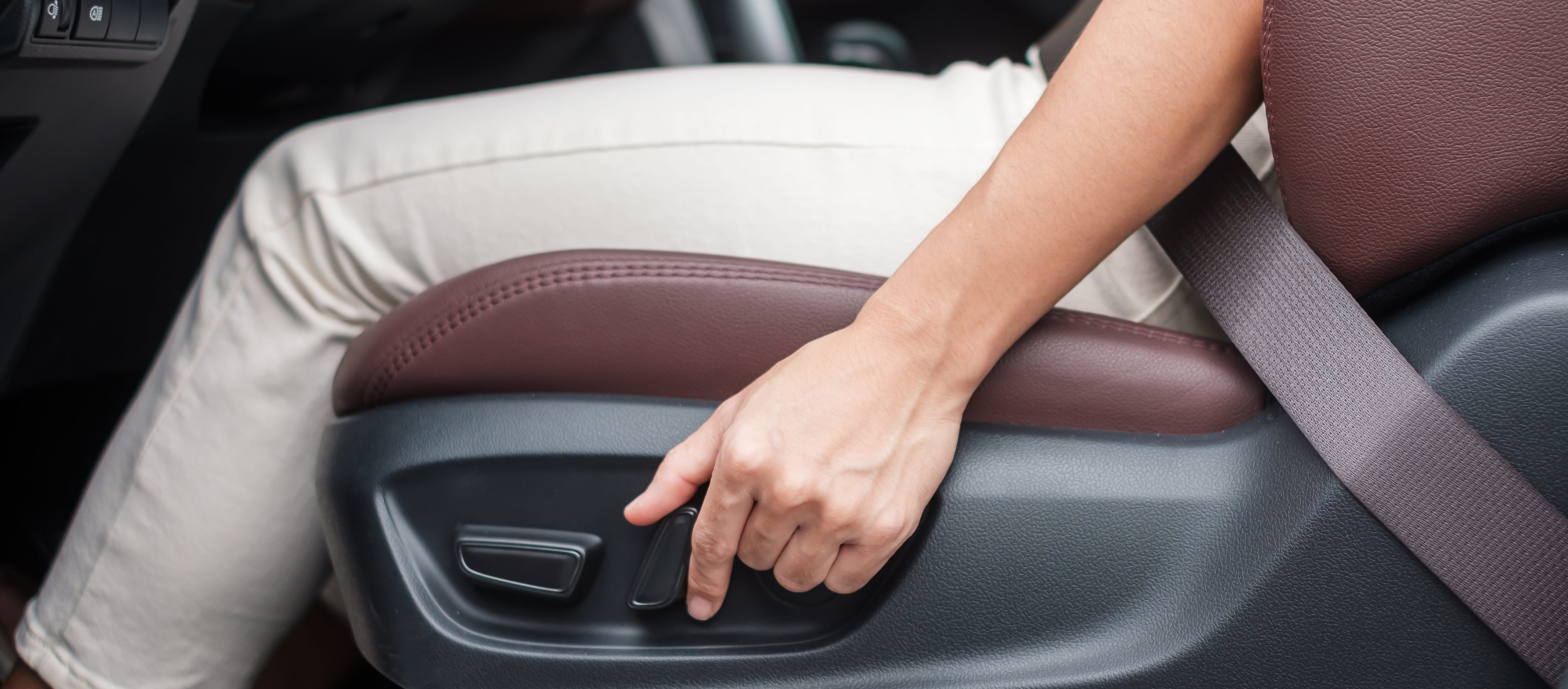 Driver adjusting the seat position during a new Subaru handover