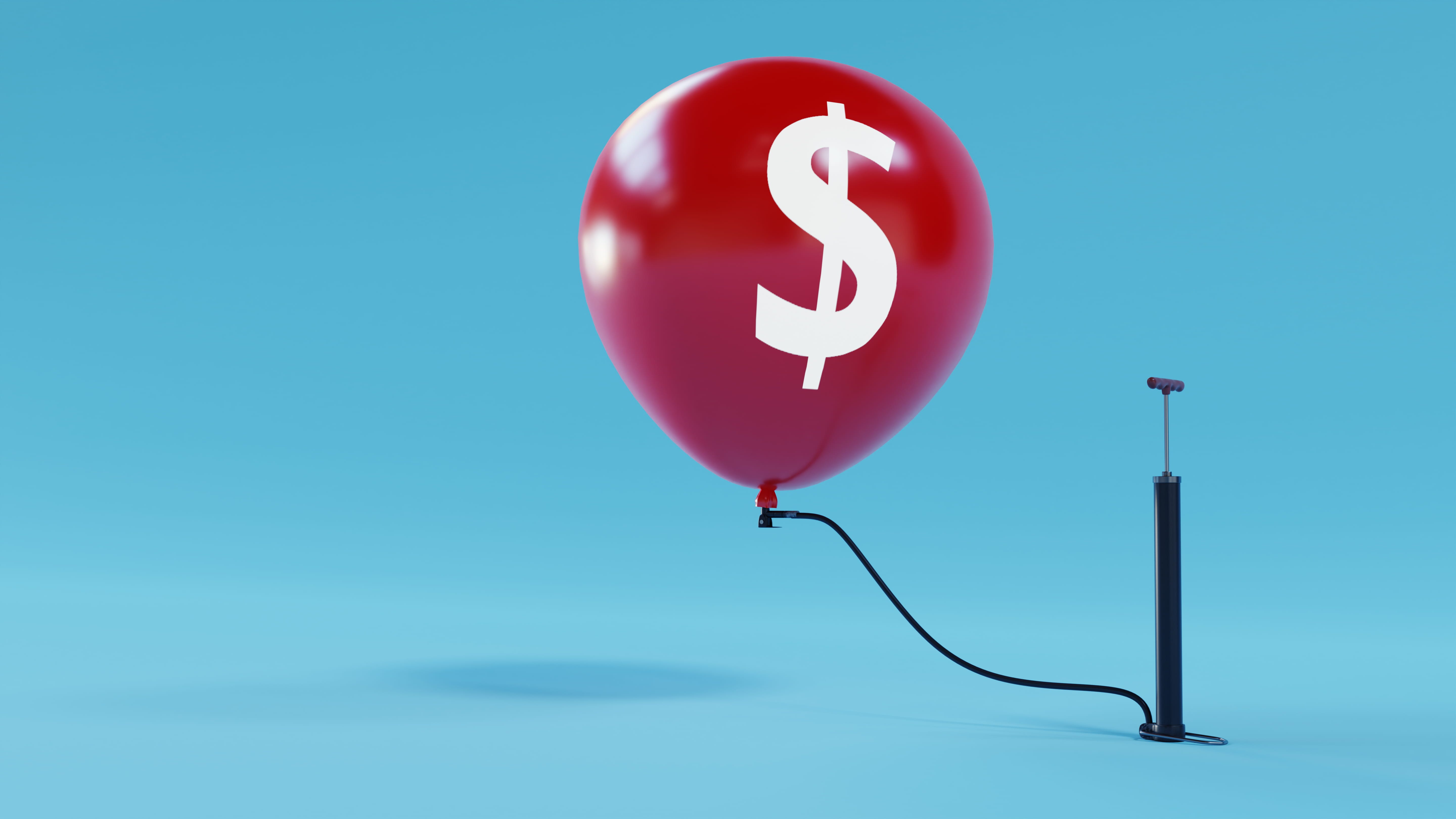 A red balloon printed with a dollar sign being inflated with a hand pump, representing a car loan balloon payment.