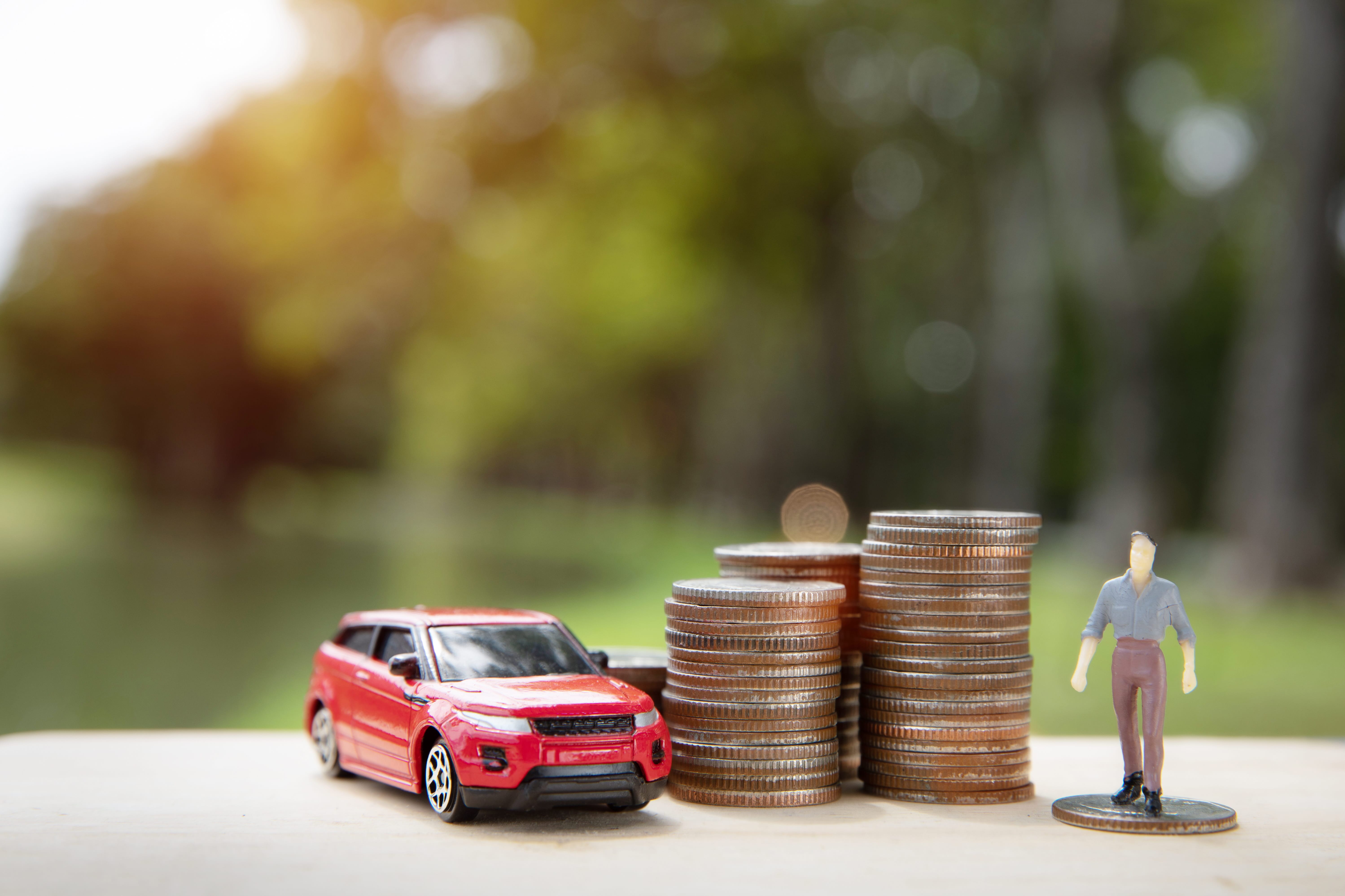 Car keys exchanged for cash between two people beside a parked car, representing a private car sale as an alternative to a dealer trade-in