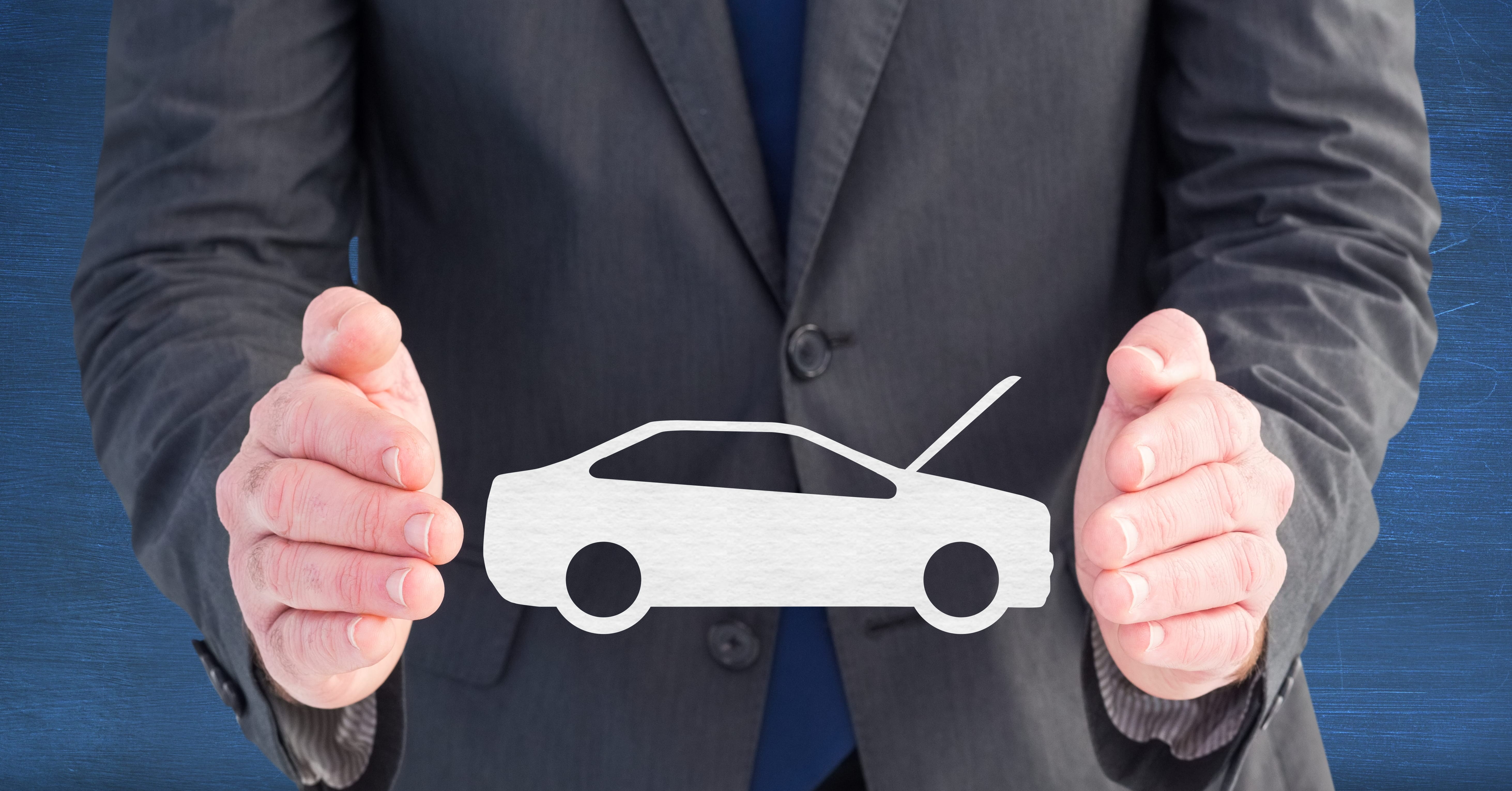 Person holding a car symbol to represent car insurance