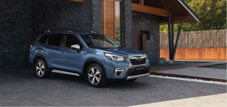 A brand new blue Subaru Forester Hybrid parked in a modern driveway, representing the new car side of the Subaru demo car vs new car comparison