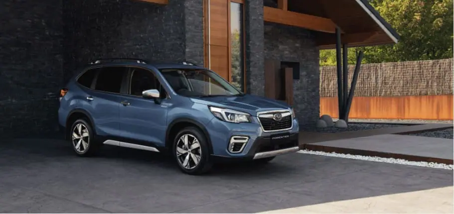 A brand new blue Subaru Forester Hybrid parked in a modern driveway, representing the new car side of the Subaru demo car vs new car comparison